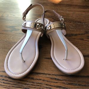 White Coach t-strap Catherine sandals with gold accents. Beige/nude straps.